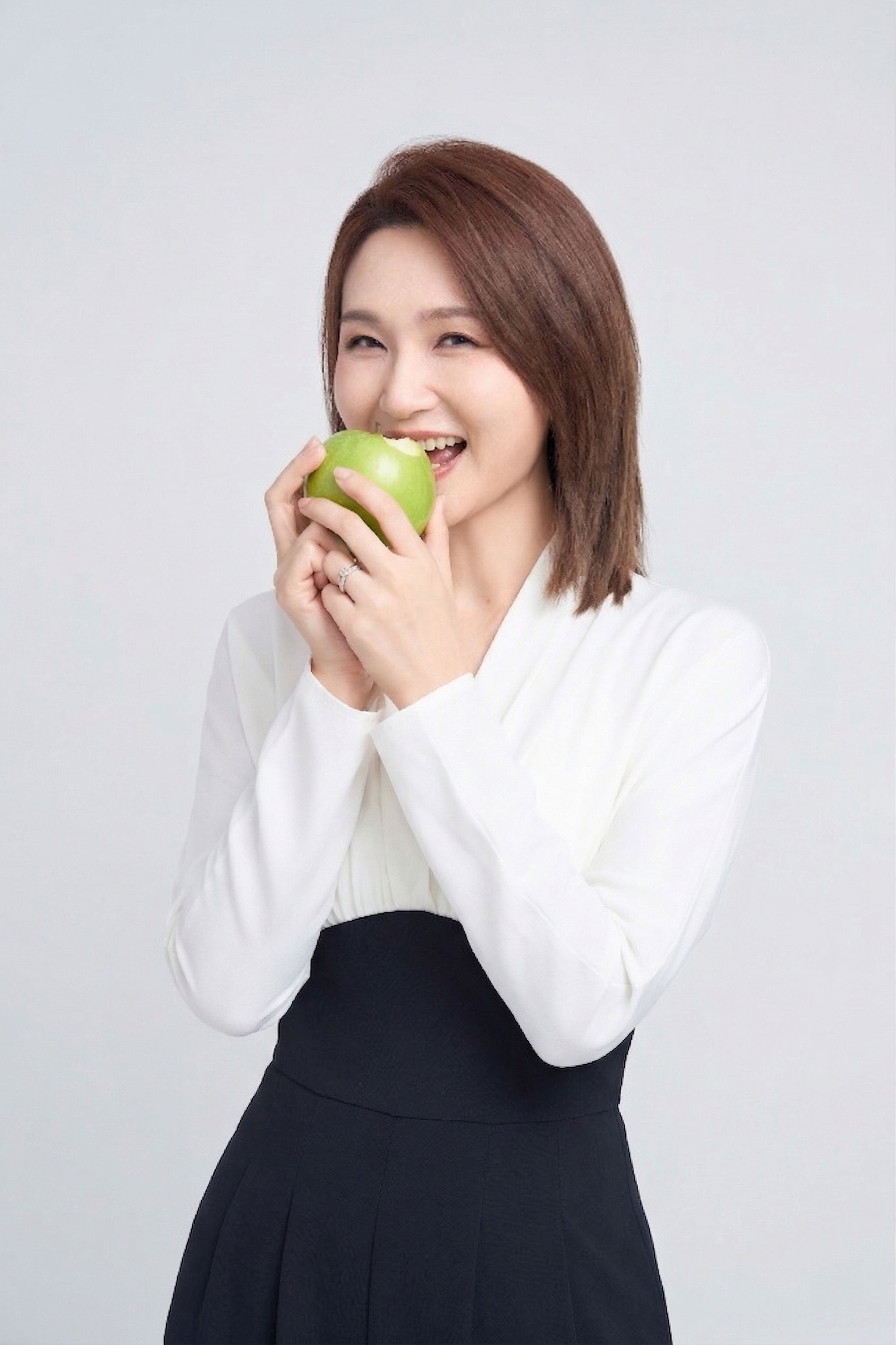 Dr. Jiang eating a green apple